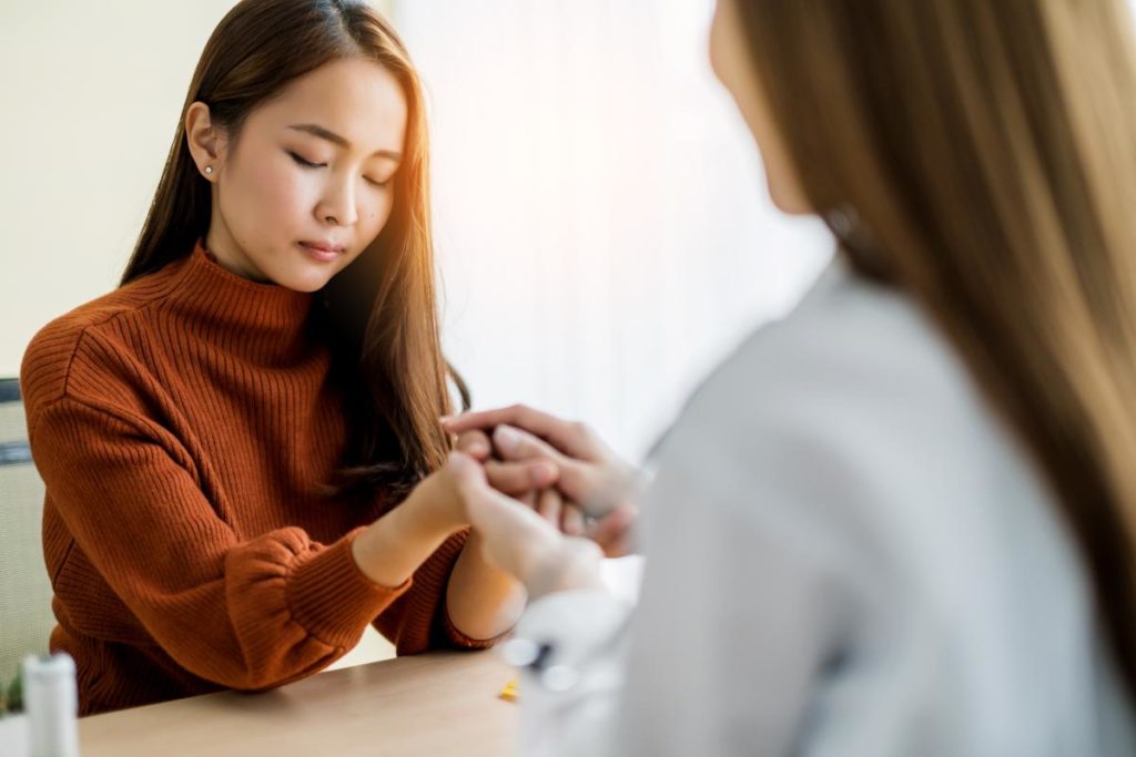 a woman discusses how to support a loved one during alcohol rehab with a therapist