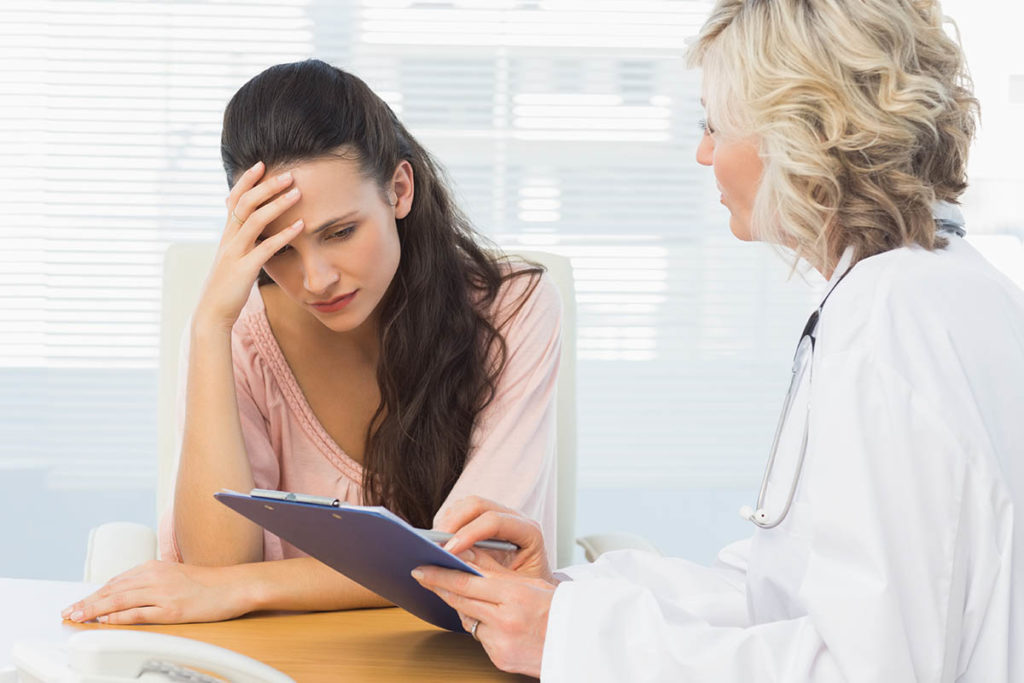 a person talks to a doctor possibly about recognizing the signs of an overdose