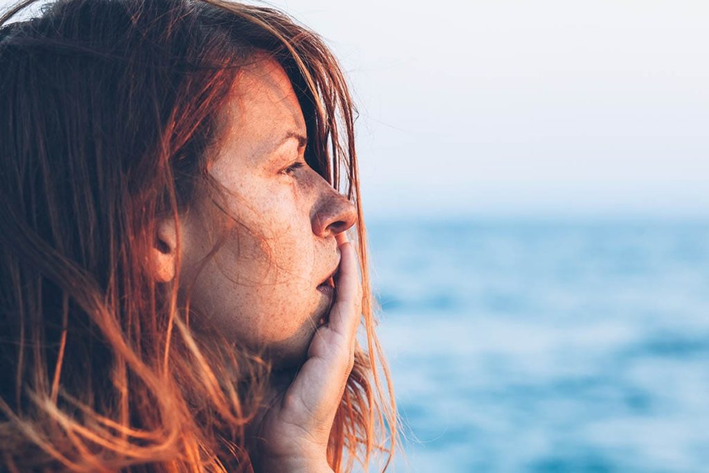 a person looks on the ocean pondering painkiller abuse
