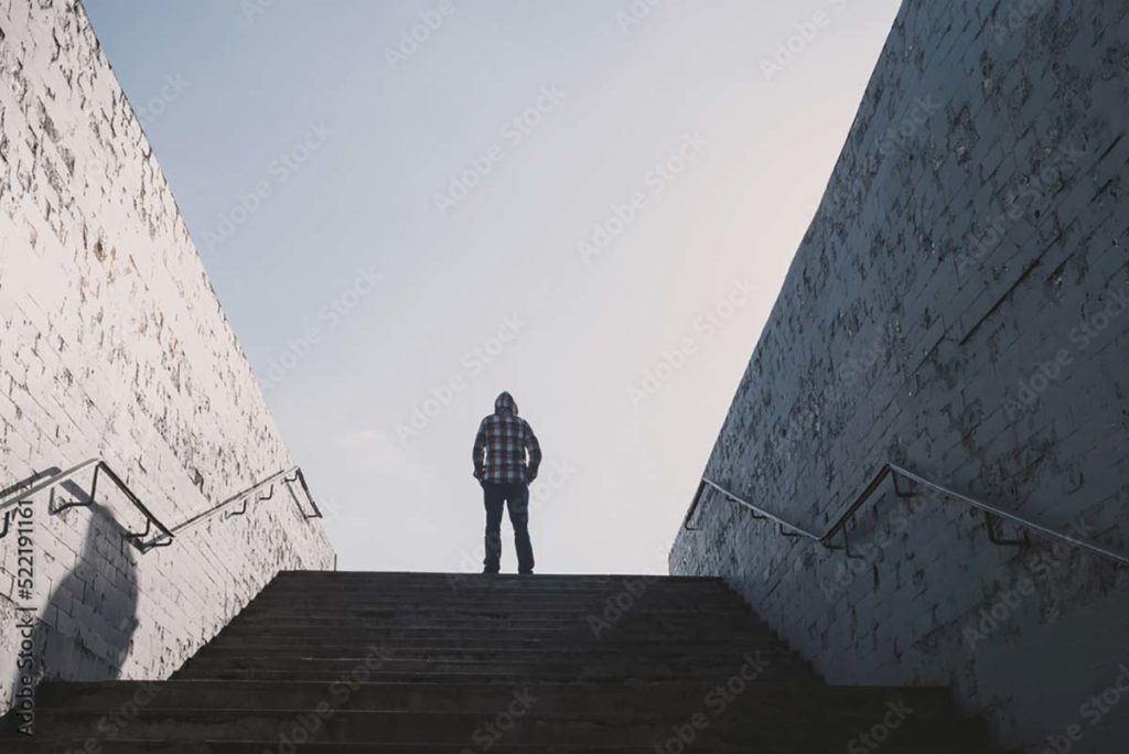 man standing up outside and considering detox for alcohol